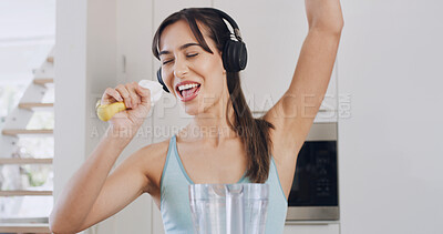 Buy stock photo Headphones, blender and singing with a woman for healthy diet, nutrition and fun in kitchen. Energy, appliance and female person with mic for smoothie, happiness or streaming music in apartment home