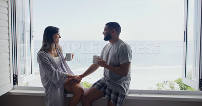 Buy stock photo Ocean, window and couple with coffee, home and holding hands with relationship, relax and discussion. Apartment, seaside and happy man with woman, talk or cappuccino with break, conversation and love