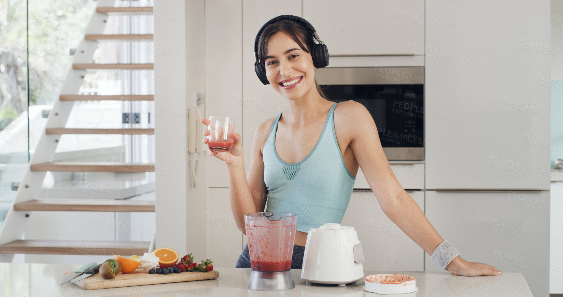 Buy stock photo Portrait, smoothie and woman in kitchen, headphones and fitness with wellness, nutrition or protein shake. Home, blender or person with gut healthy, detox or vegan juice with smile or listen to music