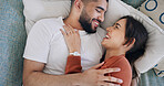 Cuddling, couple and happy on bed, home or embrace in bedroom for romance, love or bonding on break. People, together and laughing at funny joke, man and resting with woman on weekend, care and above