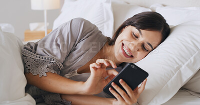 Buy stock photo Smile, mobile and woman relax in bedroom for text, message or reading post on social media. Morning, bed and girl in home with phone for communication, scroll and online chat with app notification