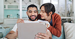 Tablet, smile and couple in living room for streaming, video and bonding on home sofa. Hug, technology and happy man with woman, website and social media or internet browsing for film and relax