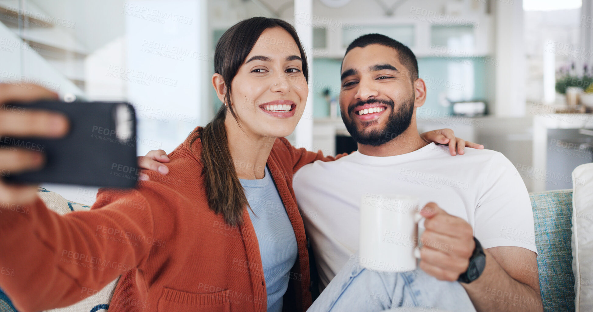 Buy stock photo Couple, selfie and smile on sofa, home and coffee for hug, care or bonding for web post in lounge. Happy woman, man and love on couch, photography and profile picture on social network at apartment