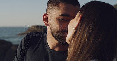 Buy stock photo Ocean, sunset and couple with love, kissing and bonding together with relationship. Beach, vacation and man with woman, romance and marriage with summer holiday, break and care with nature and trust