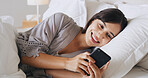 Home, mobile and happy woman relax in bedroom for text, message or reading post on social media. Morning, bed and girl with phone for communication, check app and online chat with notification