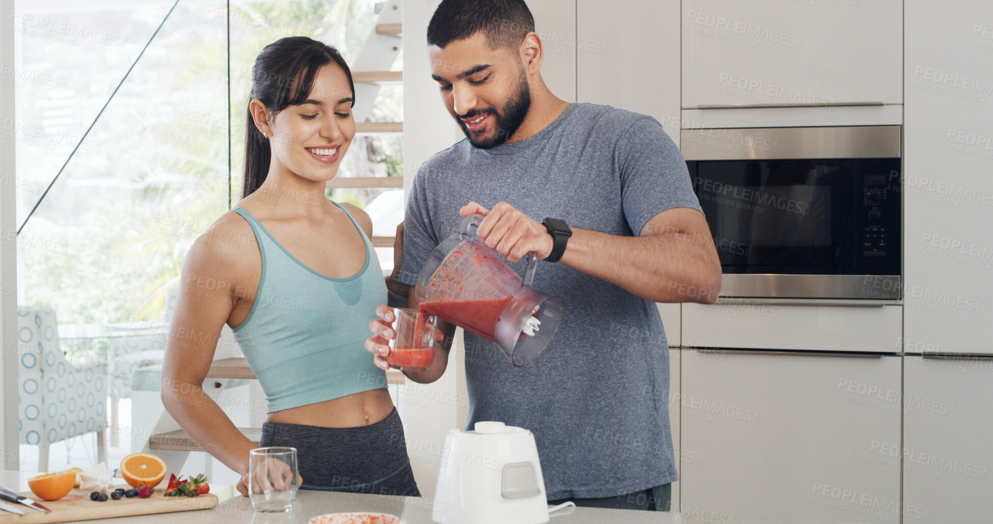 Buy stock photo Smoothie, home and couple in kitchen, smile and detox with support, gut health or wellness. Apartment, protein shake or man with woman, weight loss or nutrition with vitamins, relationship or blender