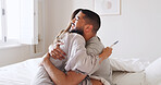 Pregnancy test, hug and love with couple in bed for ovulation prediction, celebration and good news. Cycle tracking, fertility success and support with man and woman in home for positive result