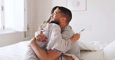 Buy stock photo Pregnancy test, hug and love with couple in bed for ovulation prediction, celebration and good news. Cycle tracking, fertility success and support with man and woman in home for positive result