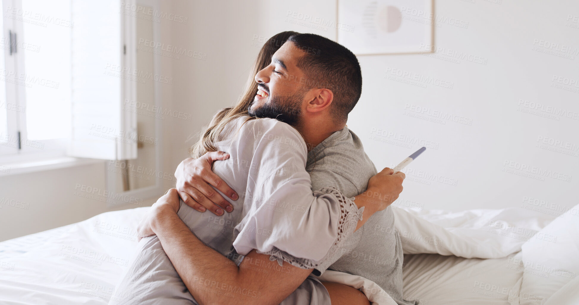 Buy stock photo Pregnancy test, hug and love with couple in bed for ovulation prediction, celebration and good news. Cycle tracking, fertility success and support with man and woman in home for positive result