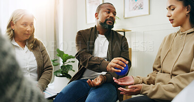 Buy stock photo People, therapist and help for group counseling with stress ball, mental health and anxiety relief. Man, speaking and community for therapy session, wellness support and technique for coping strategy