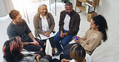 Buy stock photo Speaking, ball and therapy with people in support group for sobriety feedback, community and solidarity. Recovery check in, conversation token and counseling workshop with above of men and women