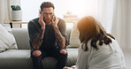 Therapy, psychologist and man with stress on sofa for mental health, trauma healing or support. Psychology, doctor and listening to patient in clinic for evaluation, consultation or help with anxiety