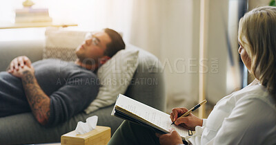 Buy stock photo Writing, therapy and sofa with man in counseling session for mental health, assessment and support. Patient report, psychologist diagnosis and treatment plan with people in office for healing