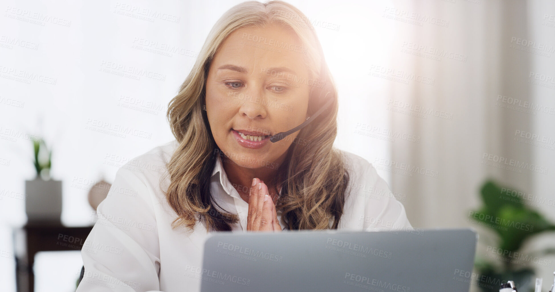 Buy stock photo Therapist, headset and video call with laptop in office for expert advice, help and support. Psychology, mature woman and virtual consultation at clinic for healing tips, online counseling and flare