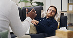 Hand, psychologist and consultation with patient on sofa, assessment and questions at clinic. Person, therapist and discussion for tips with counseling for anxiety, notes and advice for depression