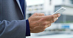 Phone, hands and businessman in city with communication, networking or finance email on mobile app. Technology, professional and male financial manager with cellphone for texting in urban town.