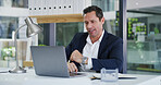 Business, laptop and reading with accountant man at desk in office for financial audit or review. Computer, finance and planning with employee person in workplace for budget or revenue analysis