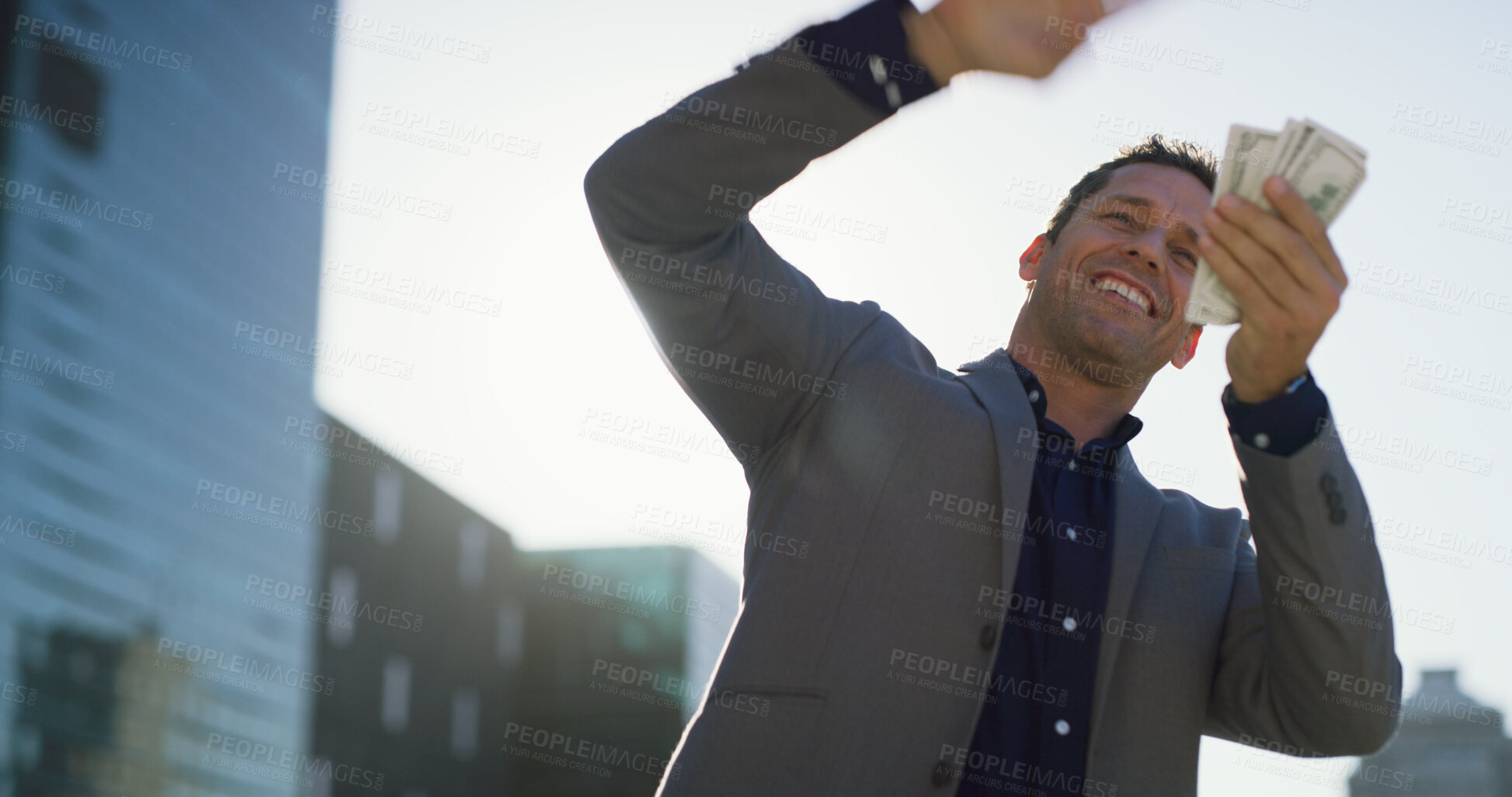 Buy stock photo Businessman, excited and money rain in city for salary, earnings and career promotion. Mature professional, cash stack and low angle in urban town for financial success, investment returns and profit