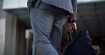 Businessman, hands and bag in city for travel, morning commute and journey to work. Professional, case and walking in town for career opportunity, punctuality and outdoor at urban office building