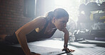 Athlete, woman and pushup for fitness at gym with exercise, strength training and workout. Female person, body balance and hard work for bodybuilding, core activity and resilience with strong muscle