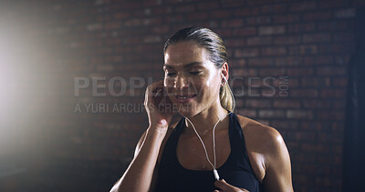 Buy stock photo Music, smile and workout with woman in gym for streaming fitness playlist, health and audio. Wellness podcast, happiness and athlete or person with earphones in sports club for exercise or radio