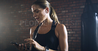 Buy stock photo Tired, earphones and woman in gym, exercise and cellphone with music playlist, app and fitness. Smartphone, exhausted and healthy person in wellness center, radio and listening to sound and fatigue