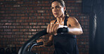 Thinking, woman and fitness with bicycle at gym for exercise, intense training and endurance. Female person, sweating and stationary bike for cardio workout, cycling performance and sports challenge