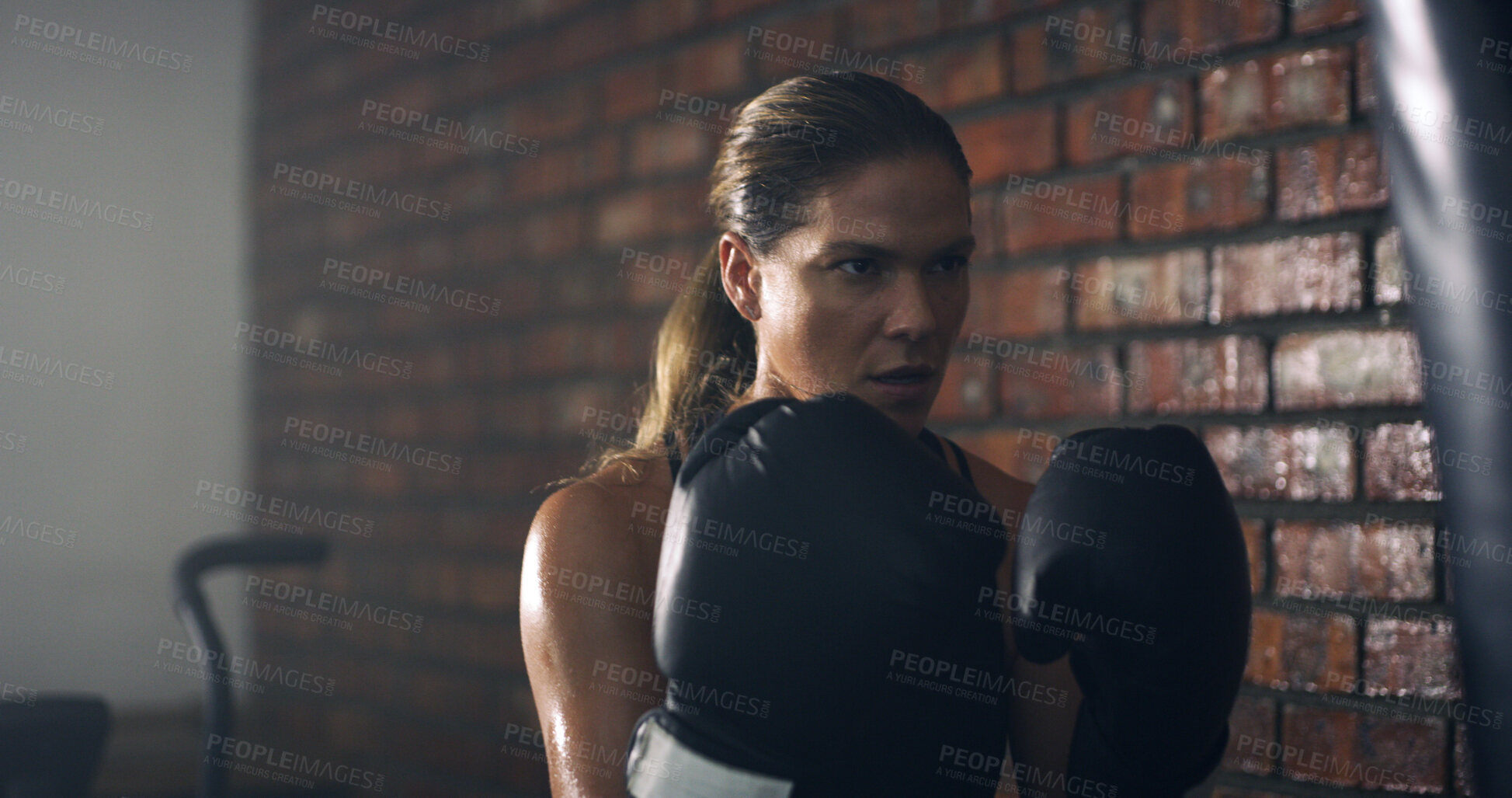 Buy stock photo Boxing, gloves and fitness with woman in gym for mma training, challenge and power drills. Workout, exercise and punching bag with person in sports club for martial arts, boxer and self defense