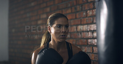 Buy stock photo Woman, boxer and punching bag at gym with exercise, routine and intense workout for fitness. Person, athlete and training for martial arts, combat sports or power with equipment for fight at club