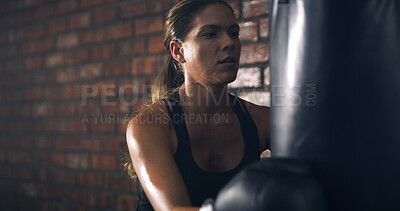 Buy stock photo Woman, boxer and punching bag at gym with fitness, routine and intense workout for exercise. Person, athlete and training for martial arts, combat sports or gloves with equipment for fight at club