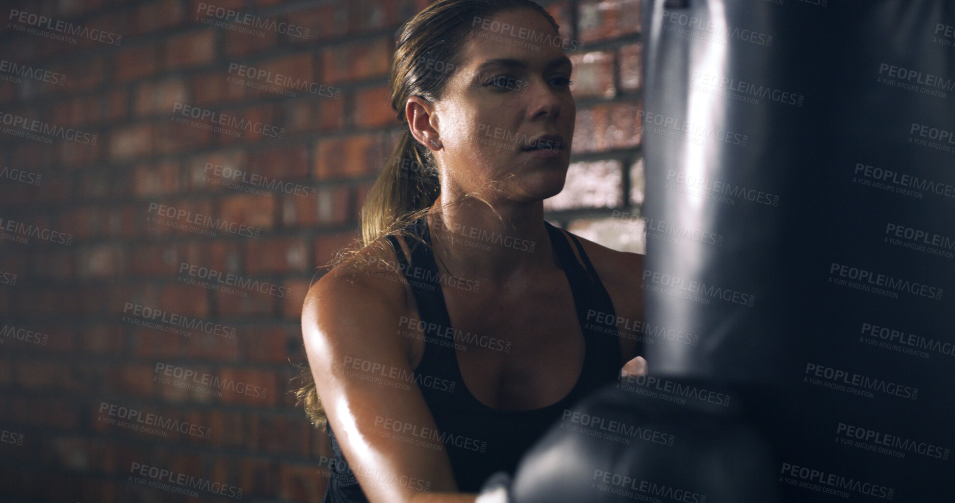 Buy stock photo Woman, boxer and punching bag at gym with fitness, routine and intense workout for exercise. Person, athlete and training for martial arts, combat sports or gloves with equipment for fight at club