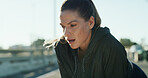 Runner, tired woman and breathing outdoor for rest, health and exercise recovery for wellness. Fitness, exhausted athlete and relax in city for break, sports fatigue and cardio challenge from workout