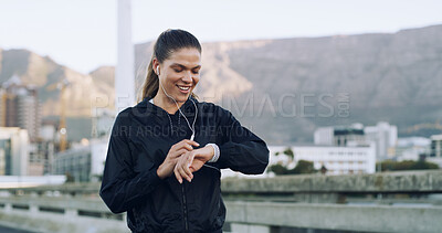 Buy stock photo Woman, runner and happy with smart watch in city with timer, stats or earphones for music with fitness. Person, stopwatch app and smile with training, results and audio streaming on bridge in Brazil