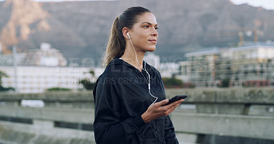 Buy stock photo Woman, runner and earphones with phone on bridge, streaming and training with music in urban town. Person, smartphone and audio subscription in city, perspective or fitness app on road in Mexico