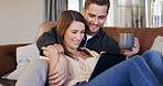 Couple, tablet and happy streaming with coffee for online film, watching video or bonding in home. Date, relax and cuddle on sofa with drink for movie subscription site, series or people in lounge
