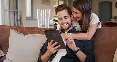 Buy stock photo Tablet, love and couple on sofa in home with social media, networking or communication online. Smile, hug and man with woman on digital technology for contact in living room together at apartment.