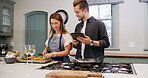 Cooking, food and couple with tablet in kitchen for dinner, supper and meal prep in home. Relationship, happy and man with woman on digital tech for online recipe, ingredients and culinary tutorial