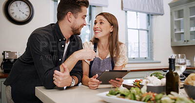Buy stock photo Cooking, talking and couple with tablet in kitchen for dinner, supper and meal prep in home. Food, happy and man with woman on digital tech for online recipe, ingredients and culinary tutorial
