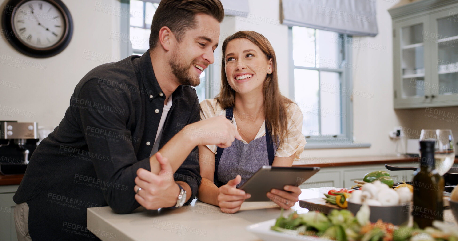 Buy stock photo Cooking, food and happy couple with tablet in kitchen for dinner, supper and meal prep in home. Bonding, help and man with woman on digital tech for online recipe, ingredients and culinary tutorial