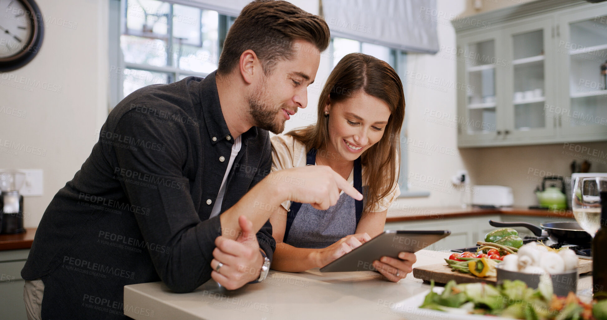 Buy stock photo Cooking, recipe and couple with tablet in kitchen for dinner, supper and meal prep in home. Conversation, food and man with woman on digital tech for online tutorial, ingredients or culinary cuisine