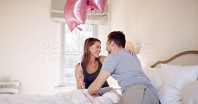 Buy stock photo Happy, couple and celebration with balloons in bedroom, hug and bonding on anniversary in apartment. Love, man and gift for woman on special day, romance and affection on bed or together in house