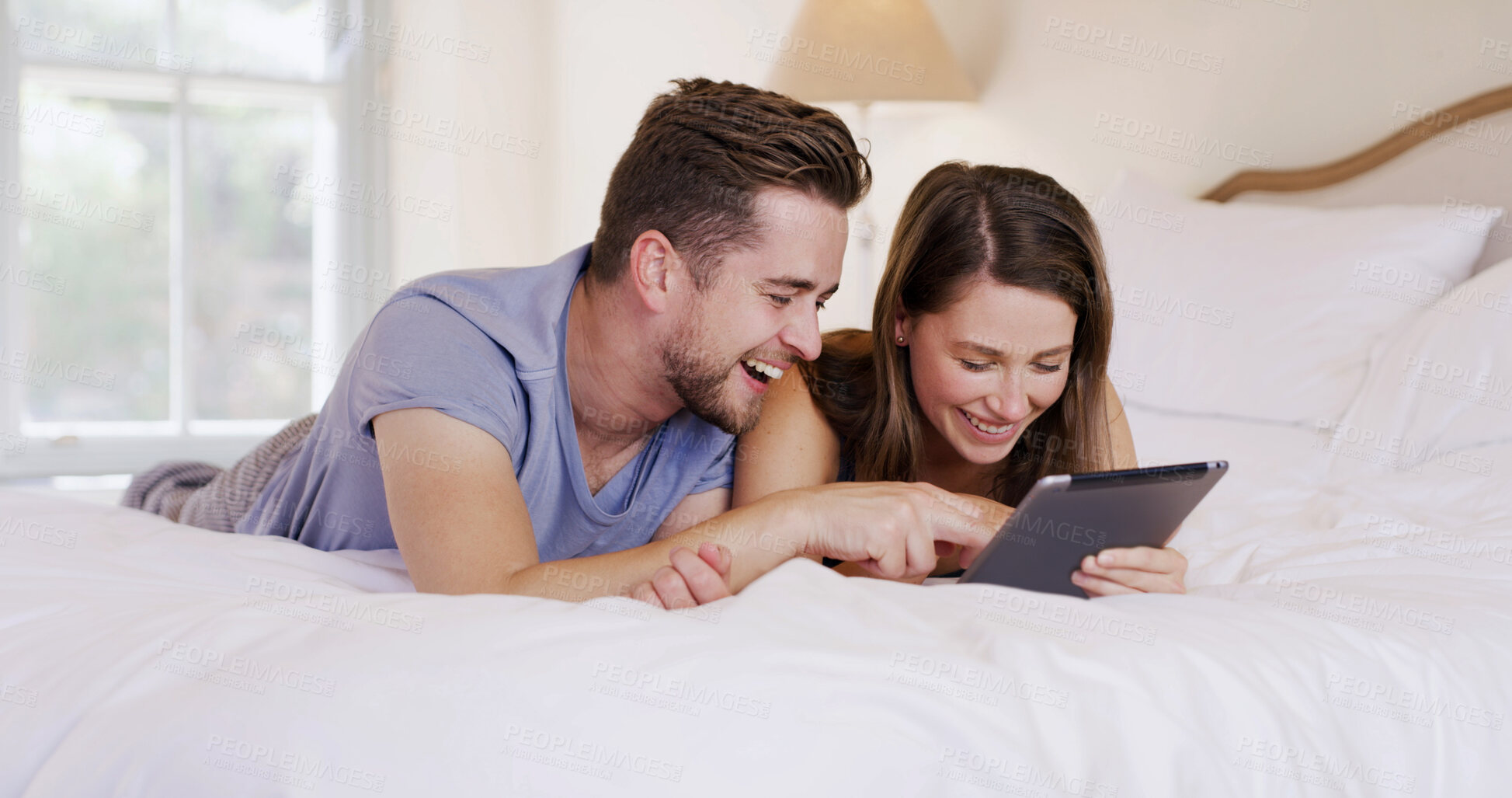 Buy stock photo Morning, couple and laughing with tablet on bed for social media meme, funny post and bonding. Relax, happy people and digital app in home for internet scrolling, weekend break and comic online video
