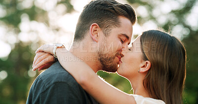 Buy stock photo Happy, kiss and couple in park for love, bonding and relationship together on weekend. Dating, nature and man with woman with affection for commitment, romance and celebrate anniversary outdoor