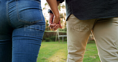 Buy stock photo Holding hands, back and couple in garden for connection, trust and marriage with bonding outdoor. People, love and care with support, commitment and walking date in nature for healthy relationship