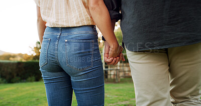 Buy stock photo Holding hands, back and couple outdoor for connection, trust and marriage with bonding in garden. People, love and care with support, commitment and walking date in nature for healthy relationship