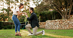 Proposal, woman and couple in nature, excited or ring for commitment in relationship, love and care. Outdoor, man and asking for marriage, engagement and happy people at park, bonding and romance