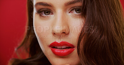 Buy stock photo Portrait, lipstick and woman in studio for beauty, makeup and cosmetology with face on red background. Lips, female person with glamour or bold color for luxury cosmetics with aesthetic and glow