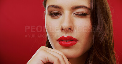 Buy stock photo Wink, lipstick and woman in studio with makeup, beauty and cosmetology on background. Red lips, female person and model with flirt, mockup space and luxury cosmetics for aesthetic and glow or shine