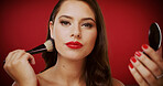 Woman, makeup brush and studio portrait for beauty with foundation, tools or mirror on red background. Girl, cosmetics product and application with powder for transformation, glow and pride in France