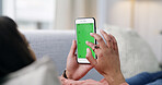 Woman, hands and phone with green screen on sofa for advertising app, UI or UX in home. Female person, relax and scrolling with mobile smartphone display for marketing or AI testing on mockup space
